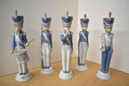 A group of five Lladro porcelain cadets comprising cadet with rifle, cadet with trumpet, cadet
