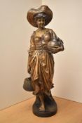 A reproduction Goldschieder style figure depicting a female water carrier, markings to backside with