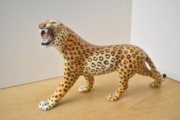 A large porcelain Leopard study, in the style of Beswick Pottery with worn markings to one foot,