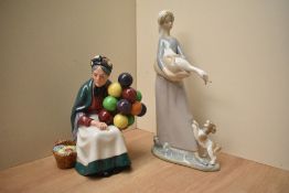 A Royal Doulton bone china figurine 'The Old Balloon Seller' HN 1315 sold together with a Lladro