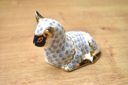 A Royal Crown Derby bone china Lamb paperweight, having Imari style decoration and silver coloured
