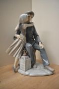 A large Lladro porcelain figure group 'The Kiss' model number 4888, measuring 35cm tall.