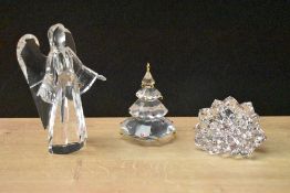 Three Swarovki Crystal items comprising angel, Christmas tree and dahlia, all boxed.