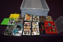 A selection of fishing flies (mostly salmon) in an assortment of boxes