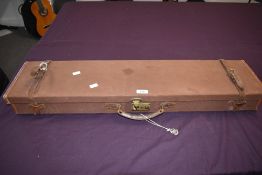 A canvas and leather gun case with keys by W W Greener lined in green velvet measuring 19cm x 88cm x