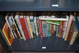 A shelf of assorted gun and cartridge related books