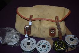 A Brady fishing bag containing 3 vintage fly reels 2 x rimfly and 1 x shakespeare