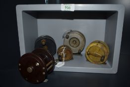 Four vintage fishing reels including two brass one by Milbro and another small trotting reel