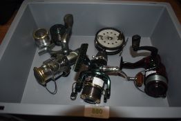 Three spinning reels by Shakespeare, Silstar and an Evox with a spare spool and one vintage fly