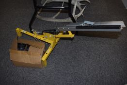 A clay pigeon trap and a box of clay pigeons