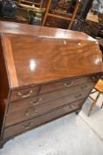 A Georgian mahogany bureau of wide proportions, having fitted interior, brass drop handles, on