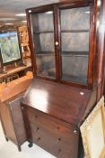 An early 20th Century mahogany bureau bookcase , the base having phenolic handles, height approx.