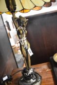 A modern table lamp having brass naked figural decoration