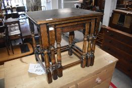 A vintage nest of three oak tables