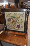 An embroidered fire screen having oak twist frame, height approx. 84cm