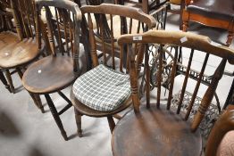 A set of four solid seat spindle back kitchen chairs