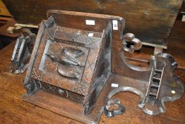 A 19th Century carved oak corner shelf with cupboard under