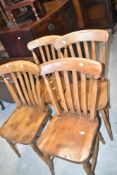 A set of four traditional stained frame rail back kitchen chairs