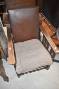 An early 20th Century oak framed recliner chair