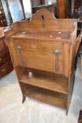 An oak Arts and Crafts style bureau having bookshelf under