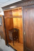 An early 20th Century mahogany bedroom suite comprising triple wardrobe, tallboy, dressing table and