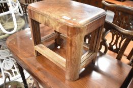 A vintage walnut nest of three small tables