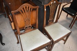 A pair of 19th Century chippendale style dining chairs having later upholstered drop in seats