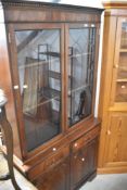 A reproduction Regency bookcase with double cupboard under, width approx. 99cm