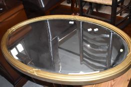 A gilt frame oval wall mirror, approx width 98cm