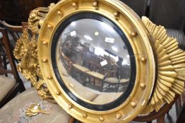 A large gilt plaster wall mirror having phoenix design to top, approx. 100 x 65cm