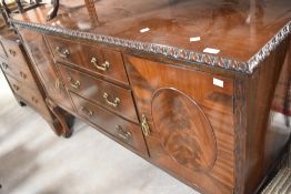 An early 20th Century mahogan sideboard having gadrooned decoration and ball and claw feet, width