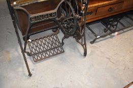 An antique cast iron sewing machine frame, similar ends and a cast iron grille