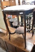 An early 2th Century mahogany occasional table having shaped top and undertier