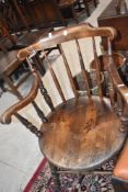 An early 20th Century oak captains style armchair