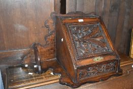 A 19th Century oak corner shelf with cupboard under, having carved decoration