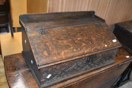 A period oak bible box, having slope top and carved panel to front, width approx. 63cm