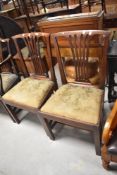 A pair of Georgian mahogany splat back dining chairs having drop on seats and square legs