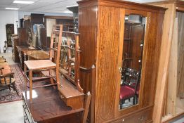 An Edwardian mahogany and inlaid bedroom suite comprising wardrobe, dressing table, three bedroom