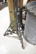 A wrought iron adjustable standard lamp in the Victorian style