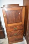 A Victorian mahogany composite narrow cabinet comprising linen cupboard over three drawers, with