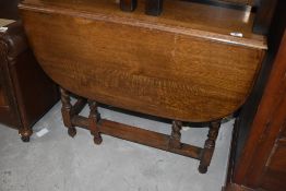 A traditional oak gateleg dining table