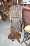 A tribal art carved palaver chair having figural decoration