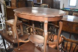 An early 20th century mahogany occasional table having shaped top and undertier
