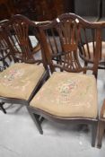 A pair of 19th Century mahogany dining chairs having drop in embroidered seats