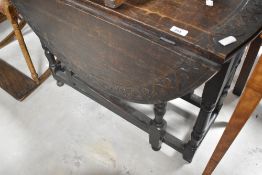 A 19th Century gateleg dining table having carved edge, width approx. 88cm