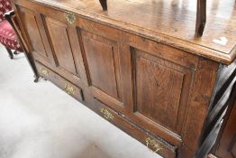 A period oak kist having four panels and two drawers to base