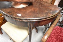 A 19th Century mahogany fold over demi lune tea table