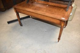 A reproduction walnut coffee table in the Regency style, approx. 97 x 51cm