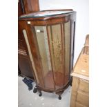 A 1950s walnut corner display cabinet