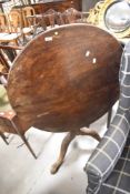 A 19th Century mahogany snap top table having circular top and triple splay legs with ball and
